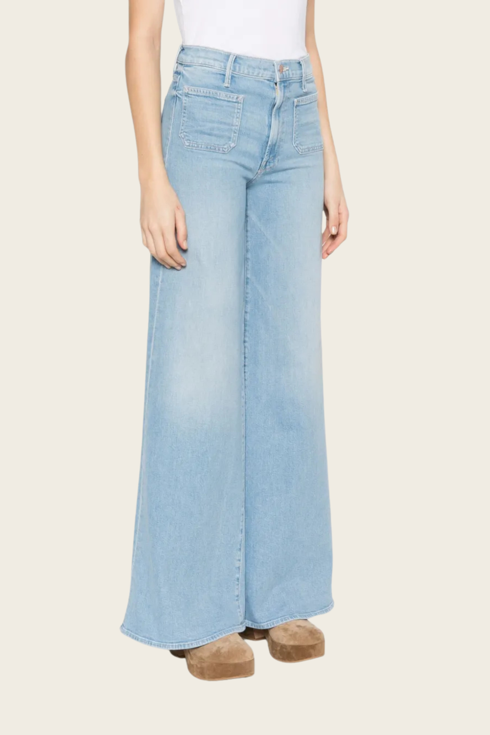 Light-wash wide leg jeans by Mother with patch pockets and a faded design.