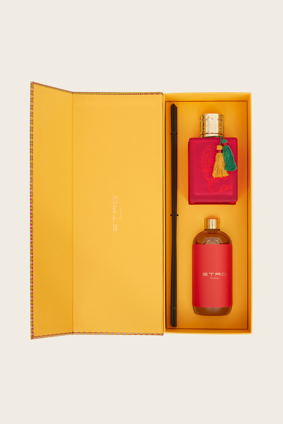 Open Etro Eos box showing a pink tasselled bottle beside an amber reed diffuser