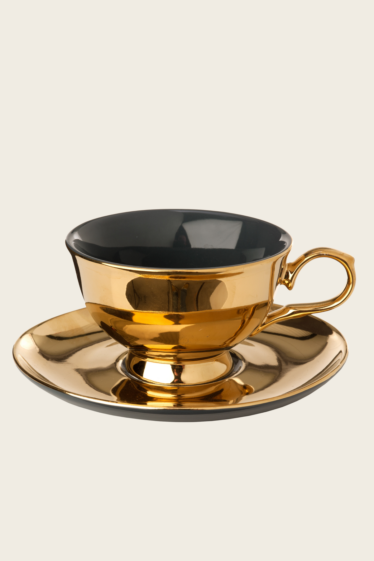 Black tea cup and saucer with gold-tone trim