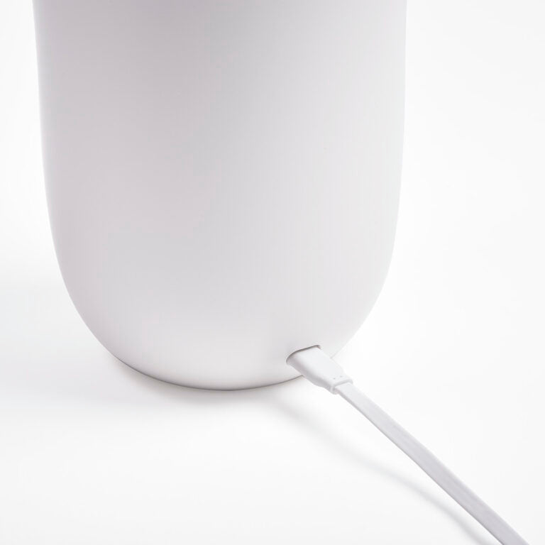 Rear of the white Oblio charger with its power cable connected