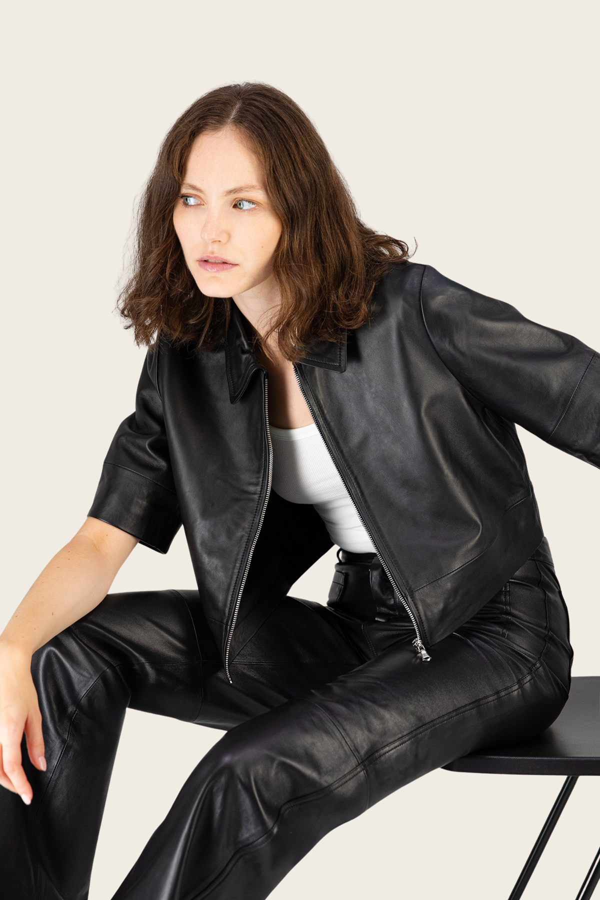 Black Vie jacket by Max&Moi, worn open while seated, showing pointed collar and front zip - espace cannelle