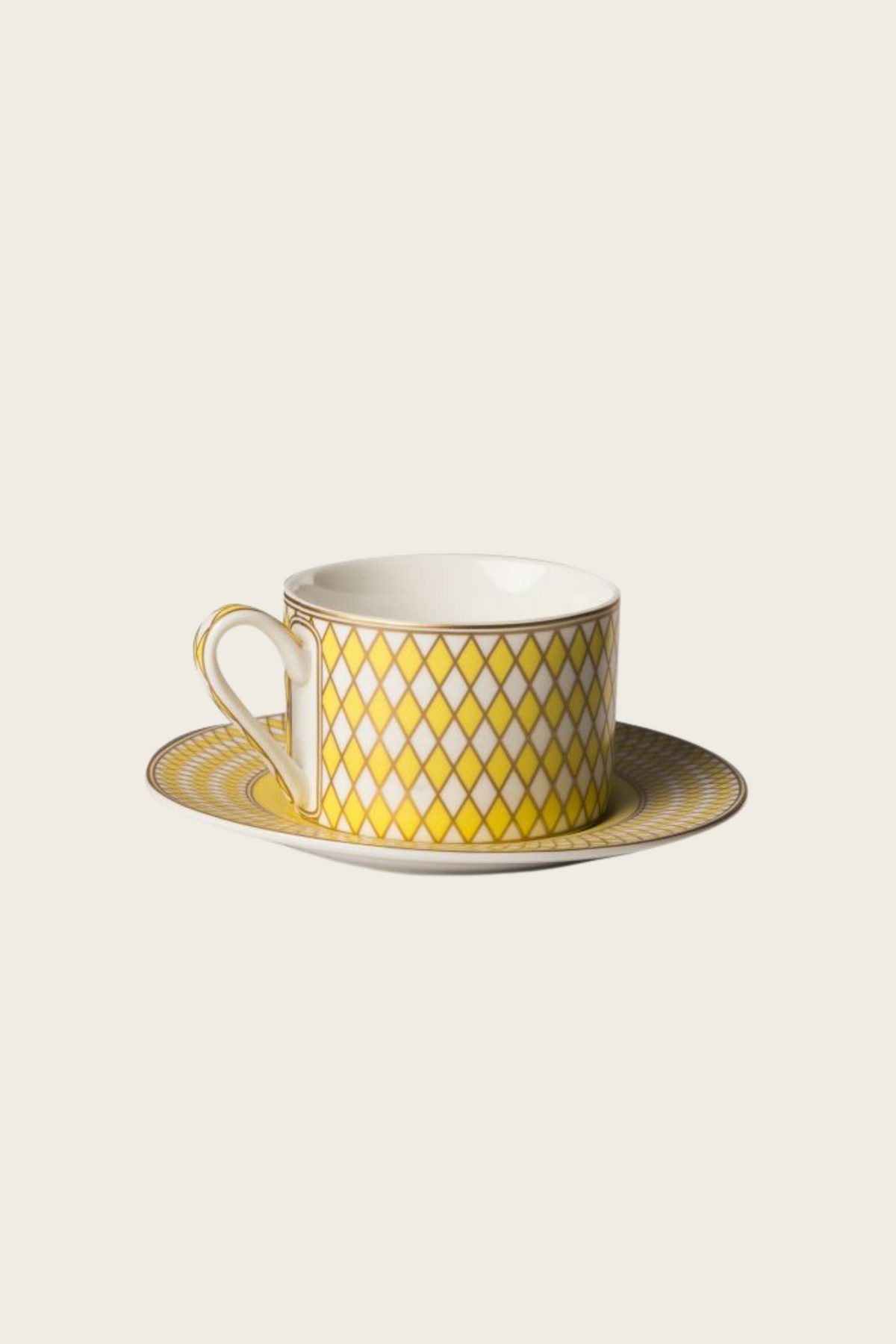 Yellow diamond-patterned Chess teacup on a matching saucer