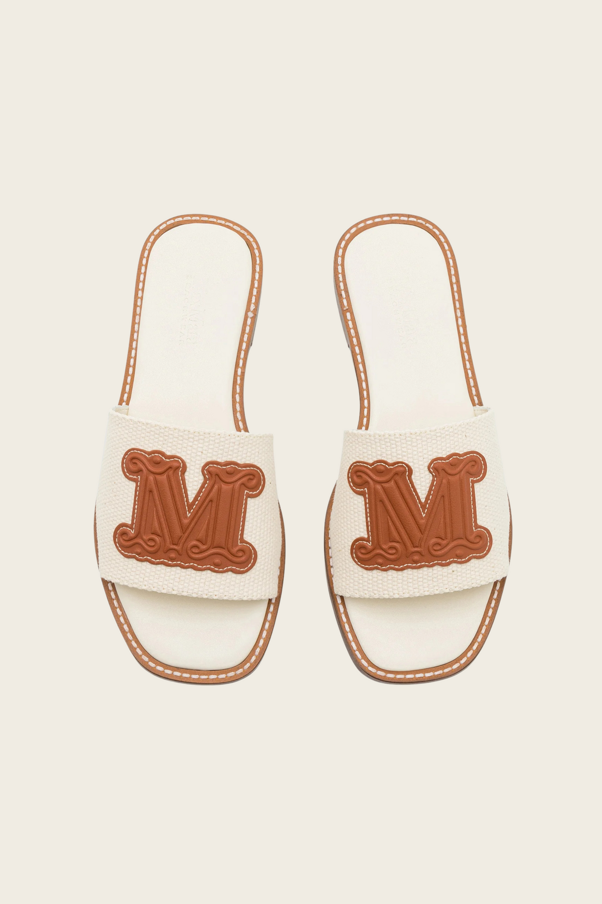 White Geneve slide sandals by MaxMara Beachwear, top view showing brown M logos and contrasting trim
