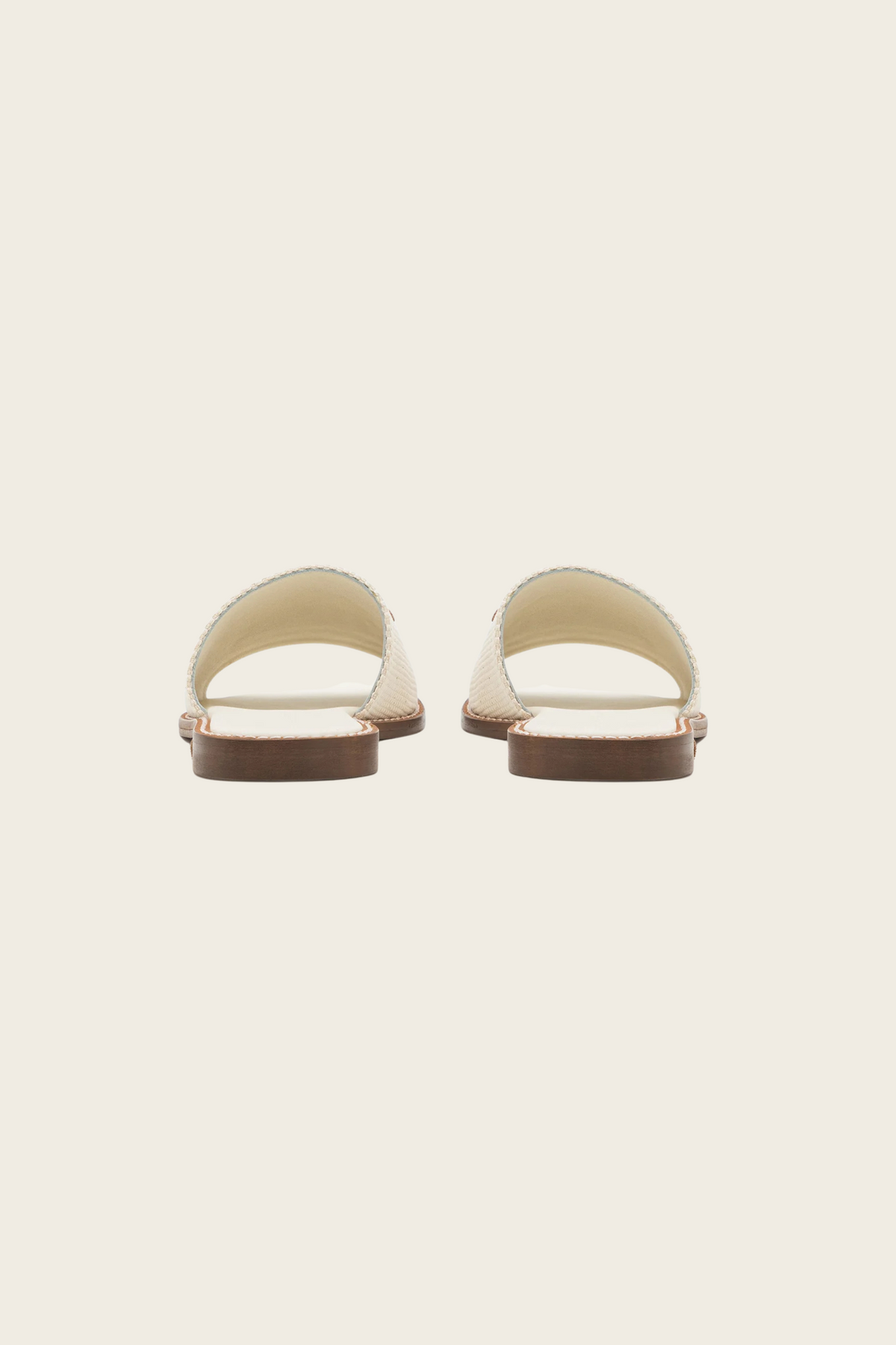 White Geneve slide sandals by MaxMara Beachwear, rear view showing open heels and contrasting brown sole edges