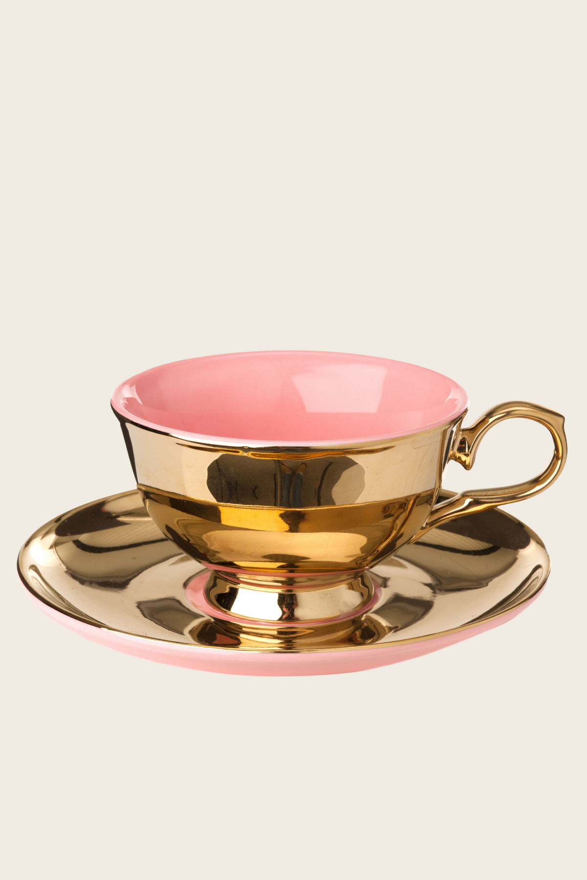 Pink tea cup and saucer with gold-tone trim