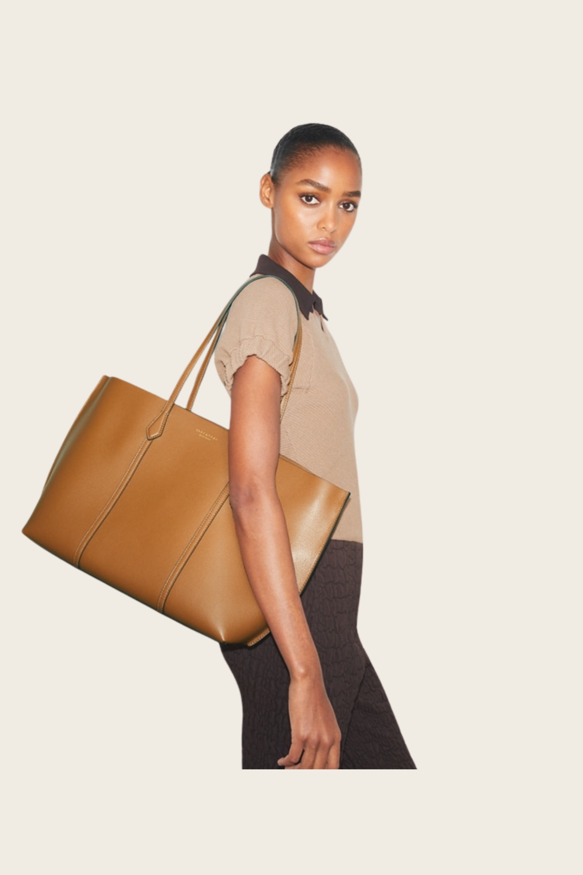 Model carrying the tan Perry tote
