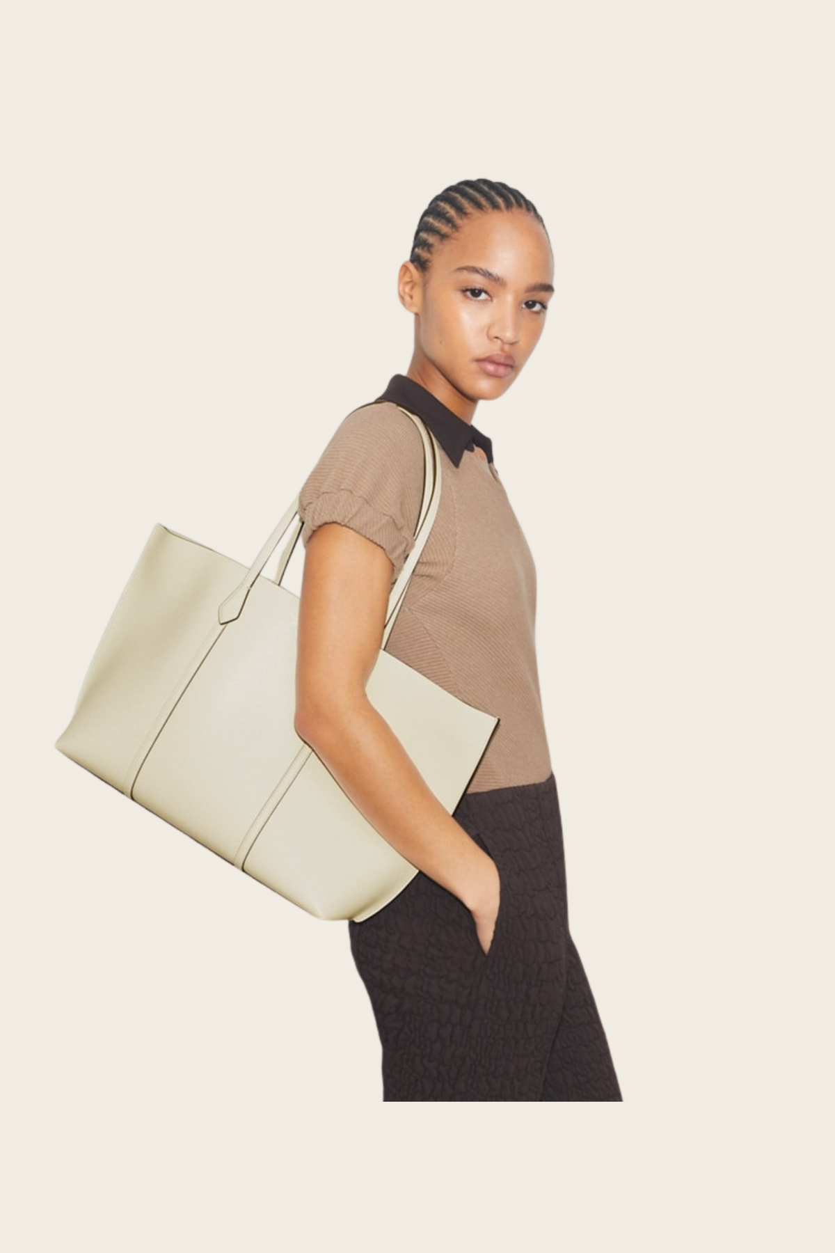 Model carrying the ivory Perry tote