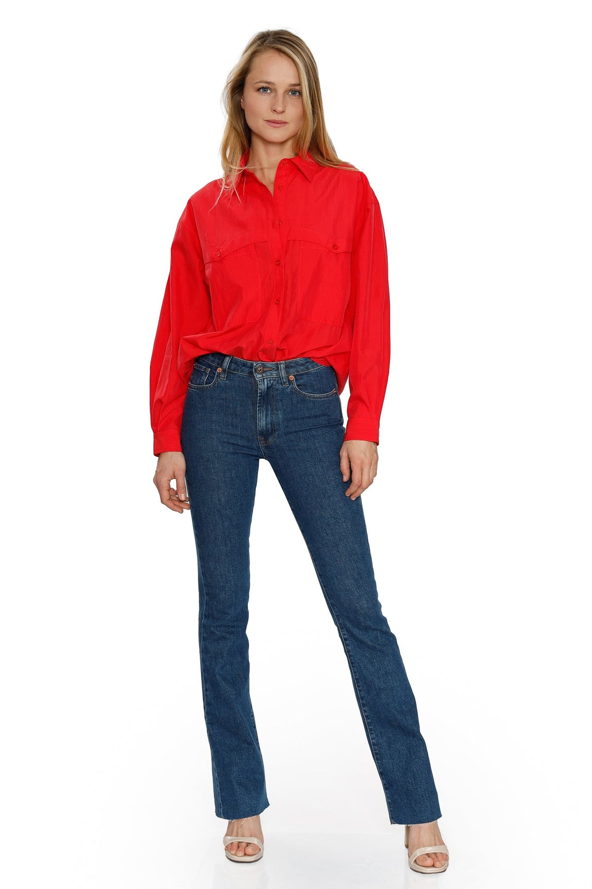 Front view of the blue Farrah flared jeans worn with a red blouse