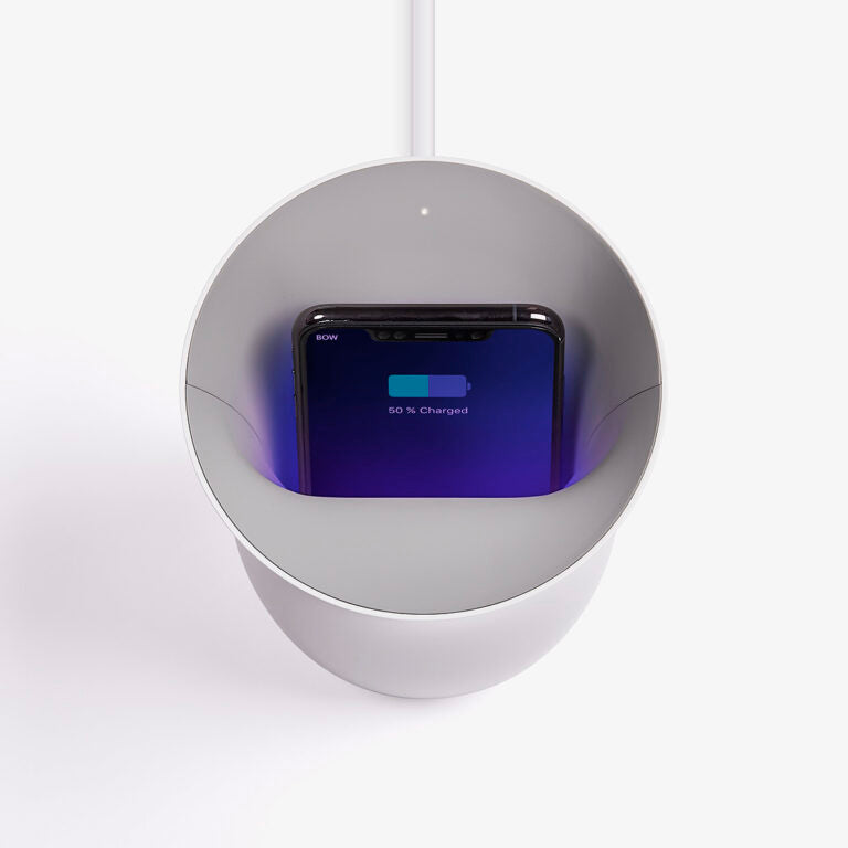 Top view of a phone inside the white Oblio wireless charger